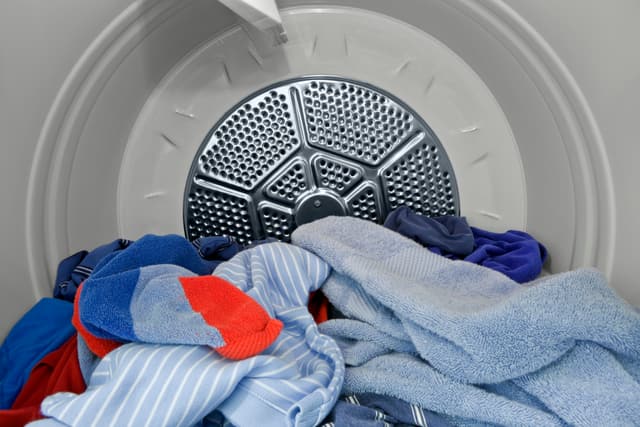 Front view of the inside of a gas dryer during a cycle